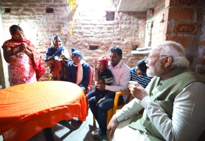 Prime Minister Narendra Modi drinking tea at Meera Manjhi's house in Ayodhya